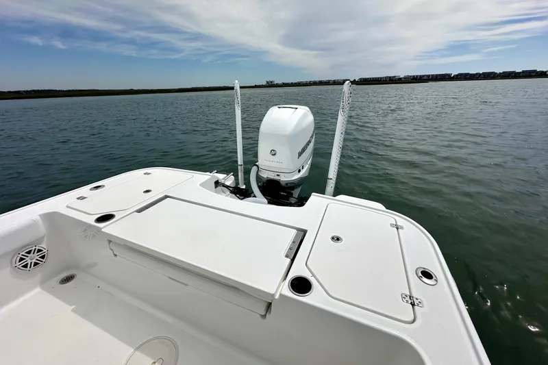 Slide: The Image of 2020 Caymas 26 HB boat with outboard motor on calm water. - 19
