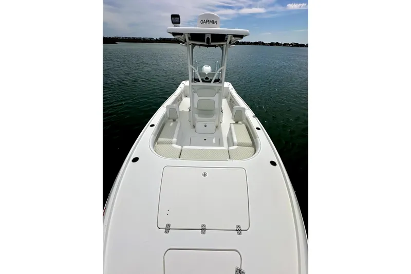 Slide: The Image of 2020 Caymas 26 HB boat on calm water, featuring a sleek white deck and Garmin equipment. - 21