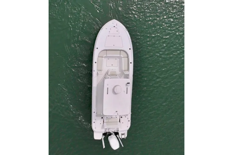 Slide: The Image of Aerial view of 2020 Caymas 26 HB boat on green water. - 25