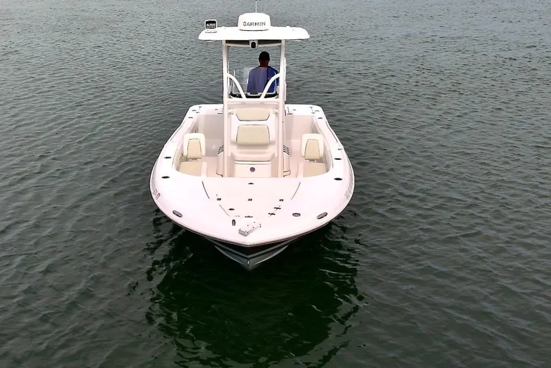 Slide: The Image of 2020 Caymas 26 HB boat on calm water, viewed from the front. - 26