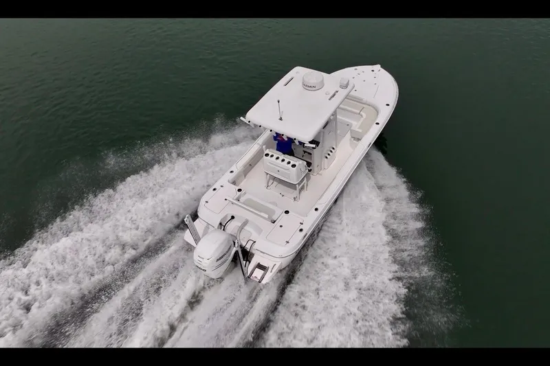 Slide: The Image of 2020 Caymas 26 HB boat cruising on water, aerial view. - 3