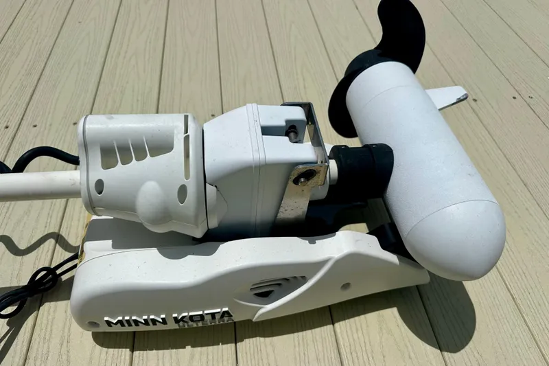 Slide: The Image of Minn Kota trolling motor on Caymas 26 HB, 2020 model, mounted on a wooden deck. - 30
