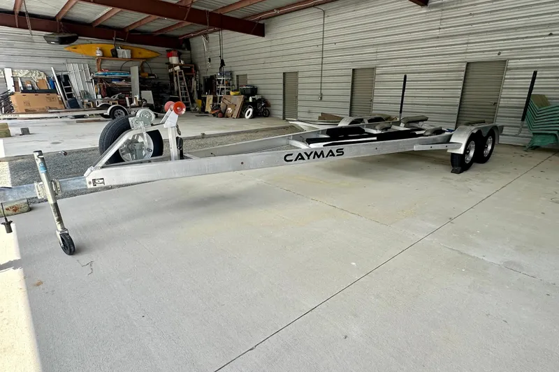 Slide: The Image of 2020 Caymas 26 HB boat trailer in a spacious indoor storage facility. - 31