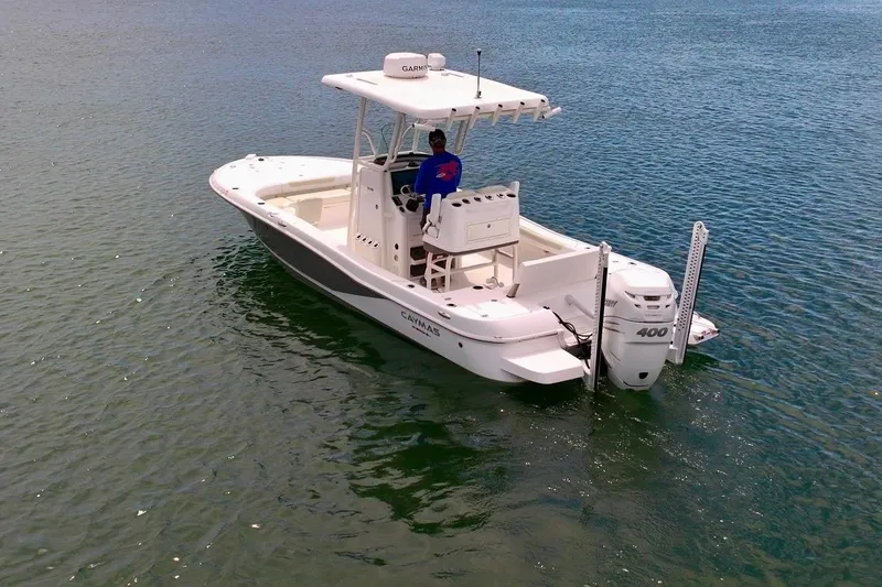 Slide: The Image of 2020 Caymas 26 HB boat on calm water, featuring a powerful outboard motor. - 4