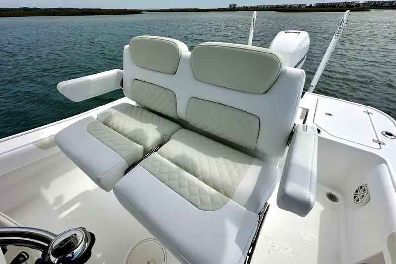 Slide: The Image of Luxury seating on 2020 Caymas 26 HB boat, featuring white cushioned seats with armrests. - 9