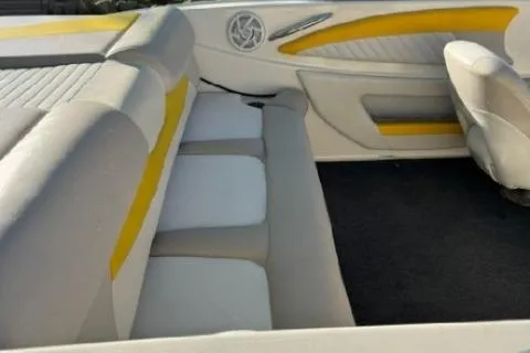 Slide: The Image of Interior of a 2007 Glastron GT 205 boat with yellow and white seating. - 10