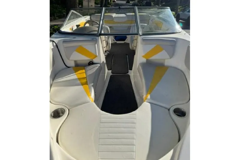 Slide: The Image of 2007 Glastron GT 205 boat interior with white and yellow seating, open bow design. - 12