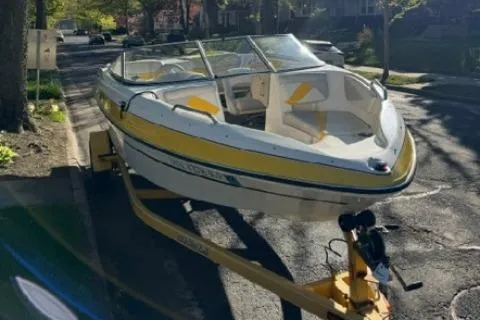 Slide: The Image of 2007 Glastron GT 205 boat on trailer, parked on a sunny street. - 4