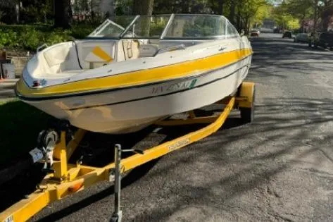 Slide: The Image of 2007 Glastron GT 205 boat on a yellow trailer parked on a residential street. - 5