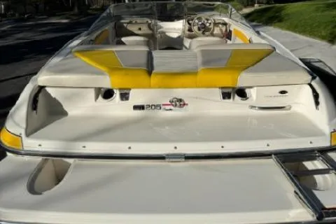 Slide: The Image of 2007 Glastron GT 205 boat with yellow accents, rear view. - 7