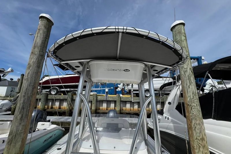 Slide: The Image of 2020 Tidewater 198 CC Adventure boat docked under a clear blue sky. - 17