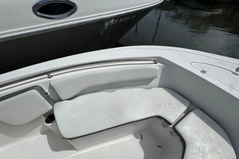 Slide: The Image of 2020 Tidewater 198 CC Adventure boat interior with white seating and stainless steel railings. - 18