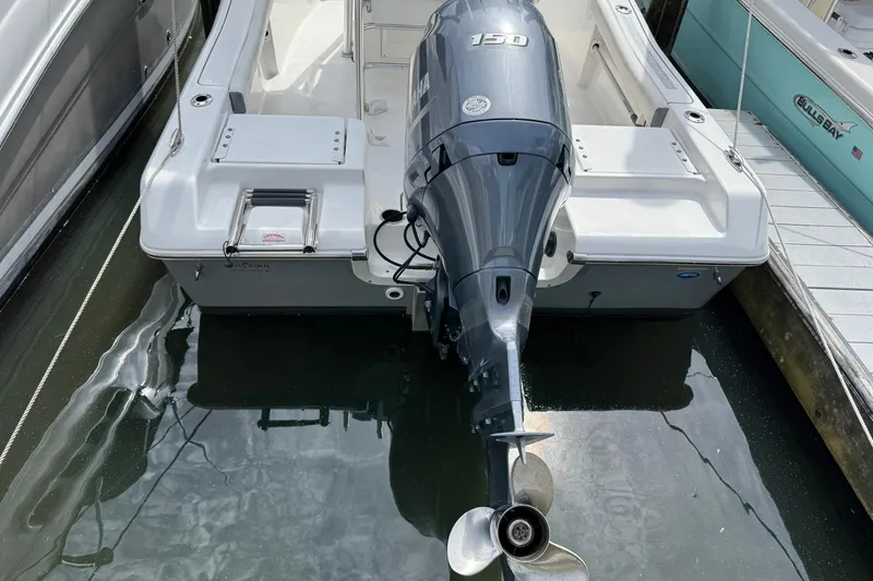 Slide: The Image of 2020 Tidewater 198 CC Adventure boat with Yamaha 150 engine docked at marina. - 2