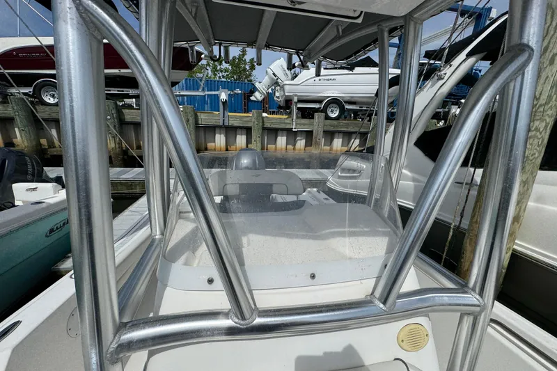 Slide: The Image of 2020 Tidewater 198 CC Adventure boat with T-top and console, docked at marina. - 20