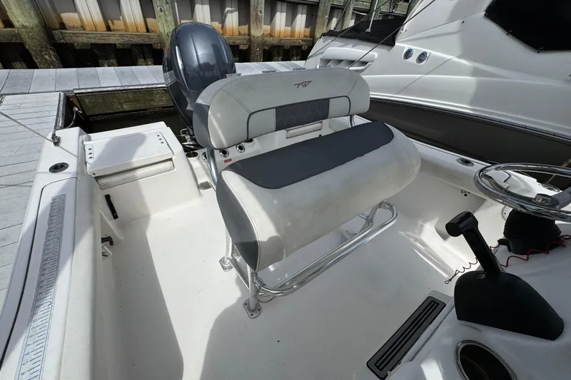 Slide: The Image of 2020 Tidewater 198 CC Adventure boat interior with seating and steering wheel. - 22