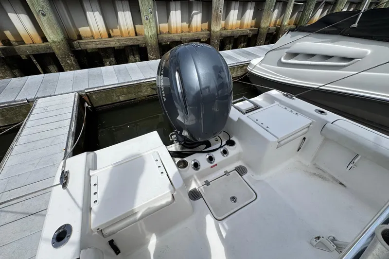 Slide: The Image of 2020 Tidewater 198 CC Adventure boat docked, featuring a powerful outboard motor. - 24