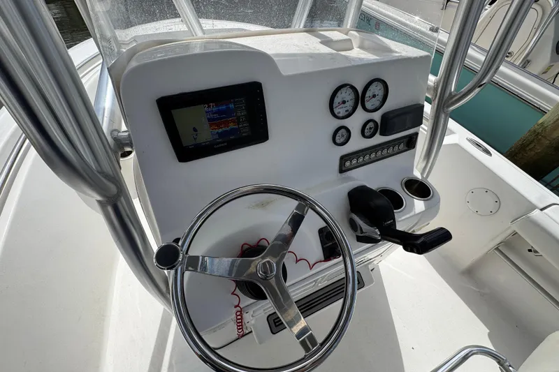 Slide: The Image of 2020 Tidewater 198 CC Adventure boat console with steering wheel and gauges. - 7