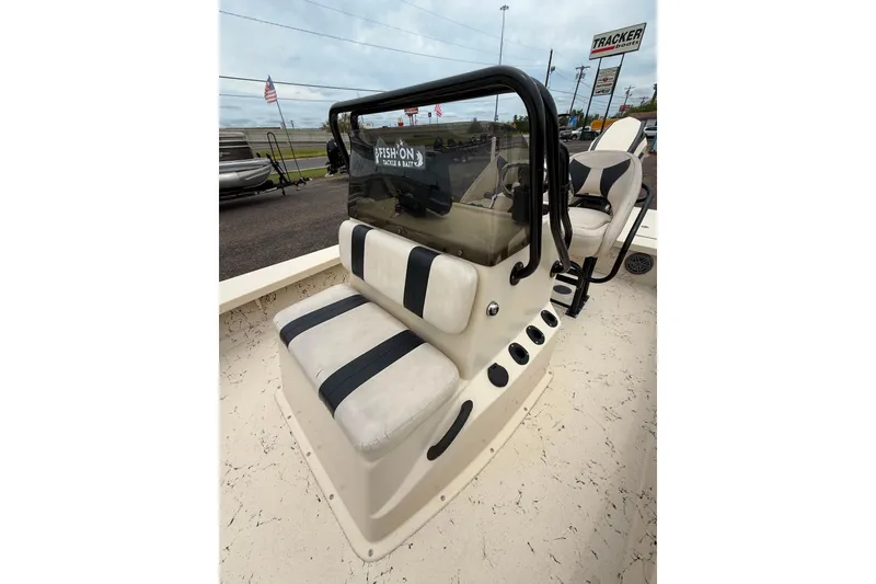 Slide: The Image of 2017 Majek 25 Xtreme boat interior with seating and console, displayed outdoors. - 11