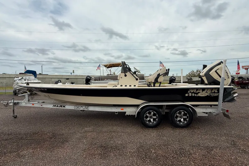 Slide: The Image of 2017 Majek 25 Xtreme boat on trailer, parked outdoors under cloudy sky. - 3