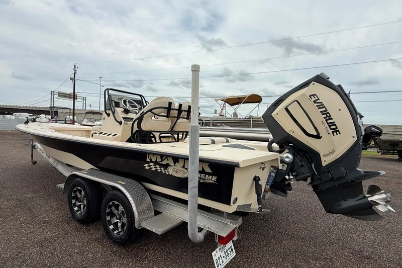 Slide: The Image of 2017 Majek 25 Xtreme boat on trailer with Evinrude engine, parked outdoors. - 4