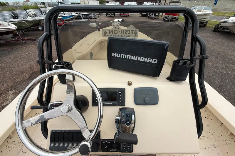 Slide: The Image of 2017 Majek 25 Xtreme boat dashboard with steering wheel and Humminbird navigation system. - 8