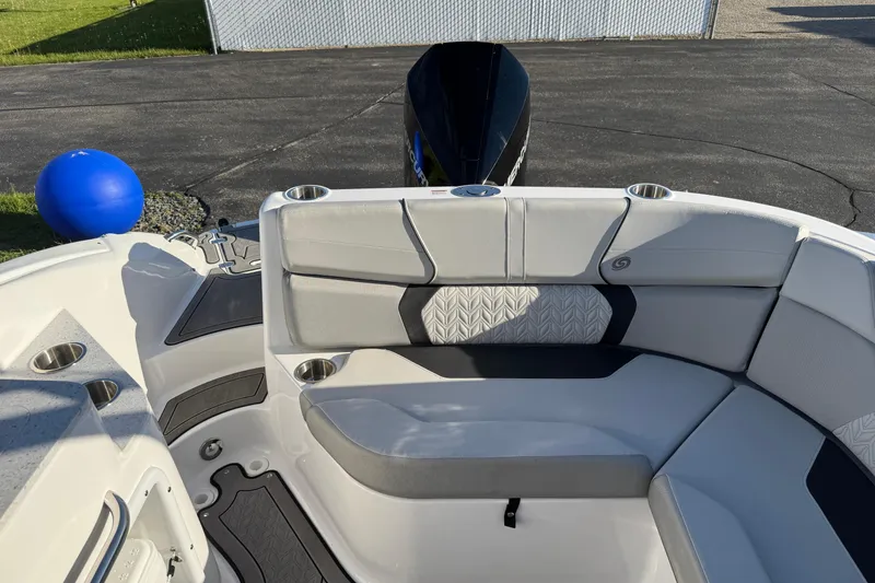 Slide: The Image of 2025 Hurricane SunDeck 2400 OB boat interior with cushioned seating and cup holders. - 11