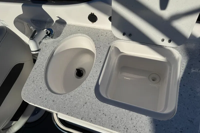 Slide: The Image of 2025 Hurricane SunDeck 2400 OB boat sink and countertop detail. - 13