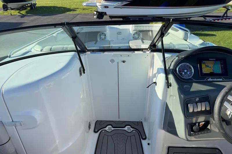Slide: The Image of 2025 Hurricane SunDeck 2400 OB boat interior with dashboard and seating area. - 24