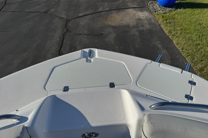Slide: The Image of Bow view of 2025 Hurricane SunDeck 2400 OB boat on pavement. - 26
