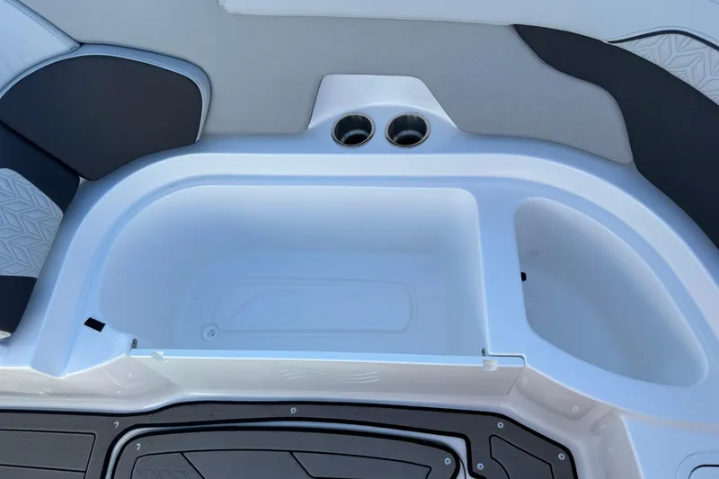 Slide: The Image of Interior view of 2025 Hurricane SunDeck 2400 OB boat with cup holders and storage compartment. - 30