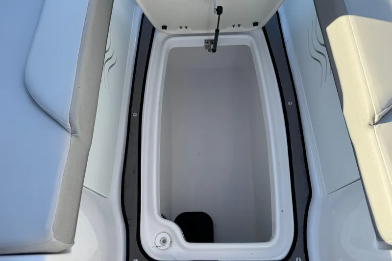 Slide: The Image of 2025 Hurricane SunDeck 2400 OB boat storage compartment with cushioned seating. - 31