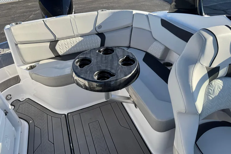 Slide: The Image of 2025 Hurricane SunDeck 2400 OB boat interior with cushioned seating and round table. - 35