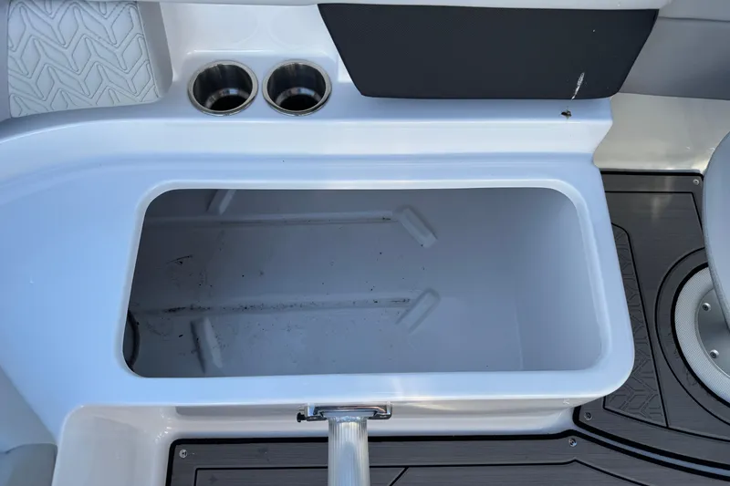 Slide: The Image of 2025 Hurricane SunDeck 2400 OB boat storage compartment with cup holders. - 36