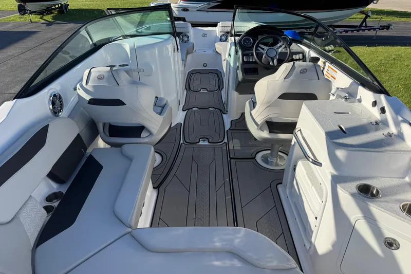 Slide: The Image of Interior of 2025 Hurricane SunDeck 2400 OB boat, featuring modern seating and steering area. - 38