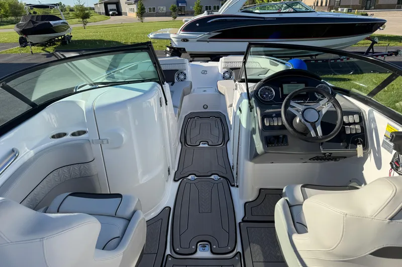 Slide: The Image of 2025 Hurricane SunDeck 2400 OB boat interior with steering wheel and seating. - 39