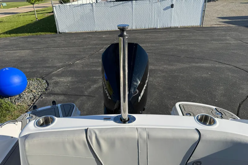 Slide: The Image of 2025 Hurricane SunDeck 2400 OB boat with Mercury outboard motor, docked on pavement. - 8