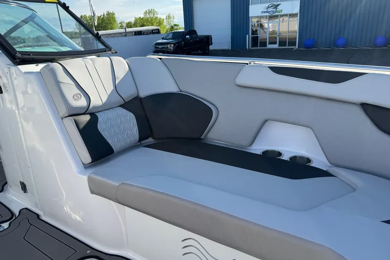 Slide: The Image of 2025 Hurricane SunDeck 2400 OB boat interior with stylish seating and cup holders. - 9