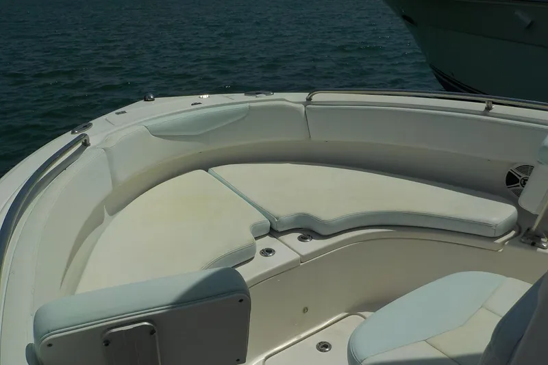 Slide: The Image of 2019 Robalo R222 Center Console boat with spacious seating area on calm water. - 17