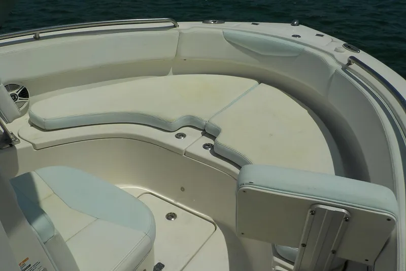 Slide: The Image of 2019 Robalo R222 Center Console boat with cushioned seating in the bow area. - 18