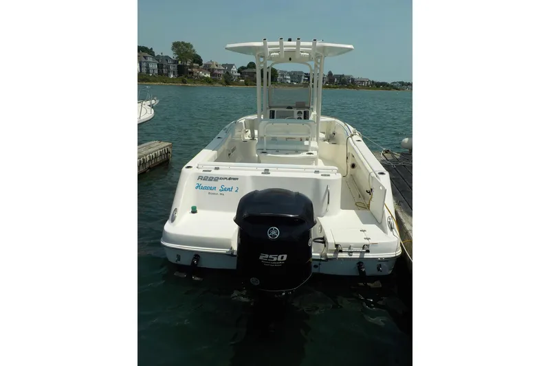 Slide: The Image of 2019 Robalo R222 Center Console boat docked on a sunny day. - 2