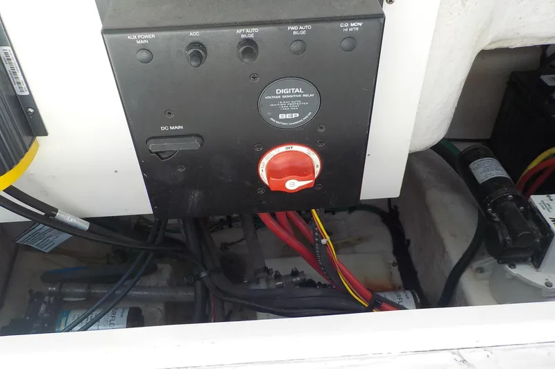 Slide: The Image of 2019 Robalo R222 Center Console electrical panel with wiring and switches. - 23