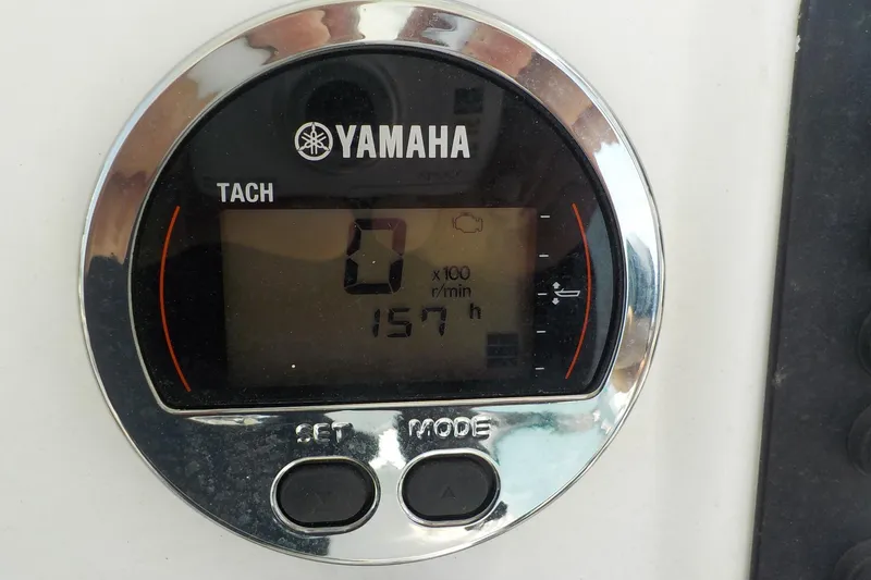 Slide: The Image of Yamaha tachometer displaying 157 hours on a 2019 Robalo R222 Center Console boat. - 3