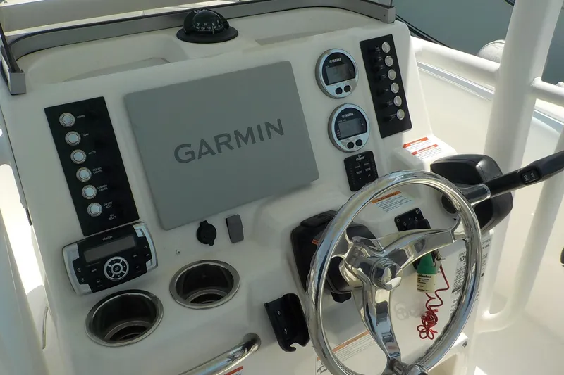 Slide: The Image of 2019 Robalo R222 Center Console dashboard with Garmin navigation system and controls. - 6