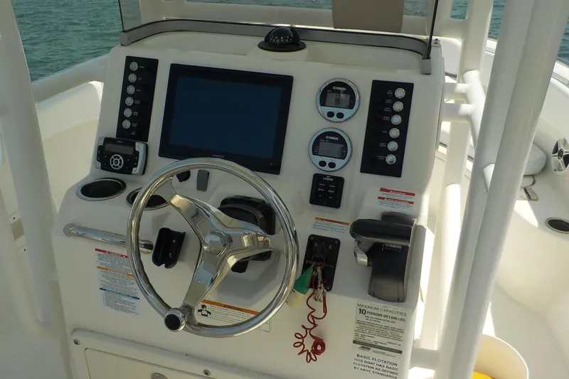Slide: The Image of 2019 Robalo R222 Center Console boat dashboard with steering wheel and controls. - 7