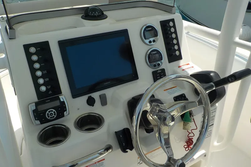 Slide: The Image of 2019 Robalo R222 Center Console dashboard with steering wheel, controls, and navigation display. - 8