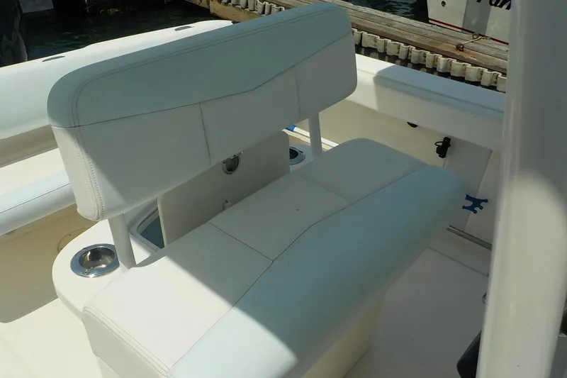 Slide: The Image of 2019 Robalo R222 Center Console boat with white seating and cup holders. - 9