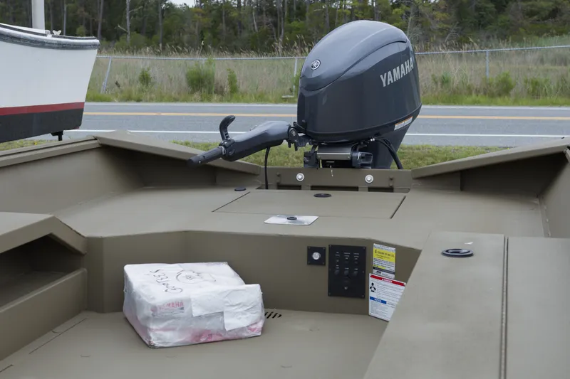 Slide: The Image of 2026 G3 Gator Tough 18 DK boat with Yamaha outboard motor, parked near a road. - 5