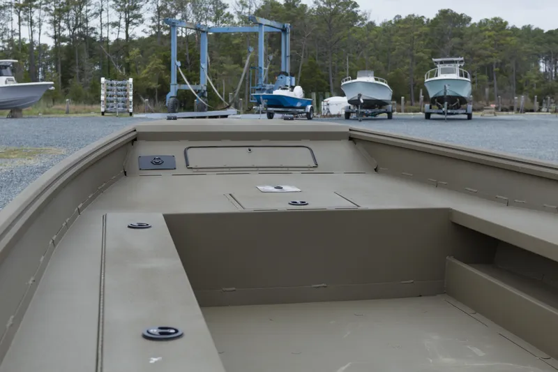 Slide: The Image of 2026 G3 Gator Tough 18 DK boat on trailer, surrounded by trees and other boats. - 6