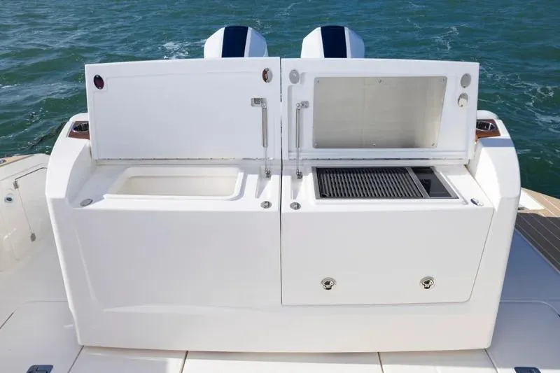 Slide: The Image of Outdoor kitchen on 2027 Tiara Yachts 39 LE, featuring grill and storage compartments. - 12