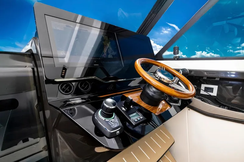 Slide: The Image of Manufacturer Provided Image: 2026 Tiara Yachts 39 LE helm with modern controls and wooden steering wheel. - 15